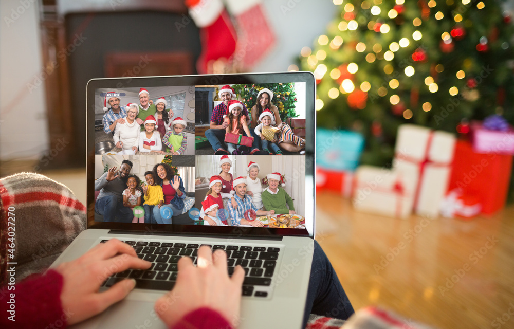 Caucasian woman on christmas laptop video call with diverse group of friends