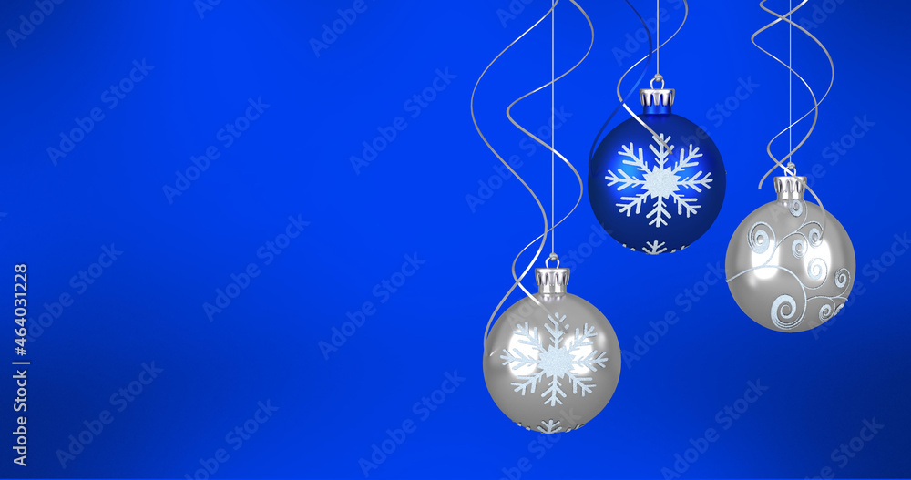 Image of christmas baubles over blue background