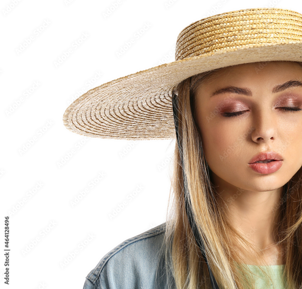 Young woman in wicker hat with closed eyes on white background