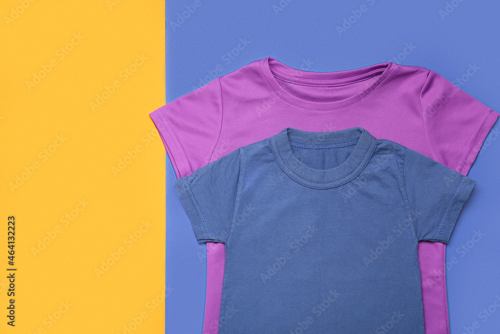 Two t-shirts on color background, closeup