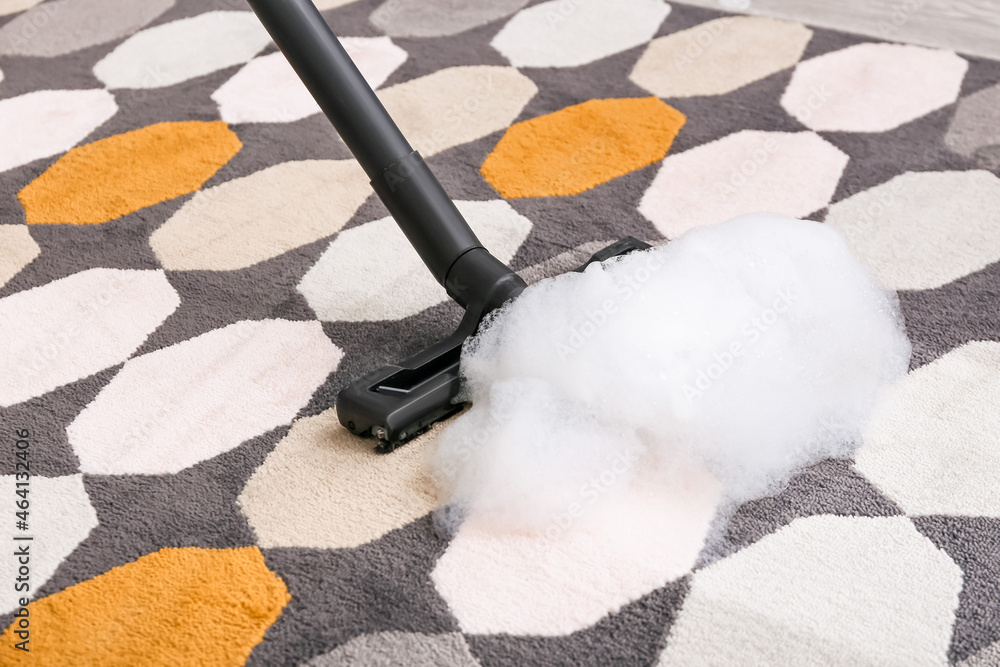 Vacuuming of carpet in room