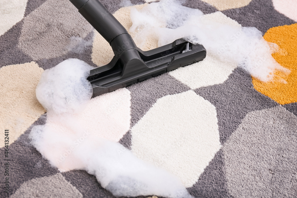 Vacuuming of carpet in room