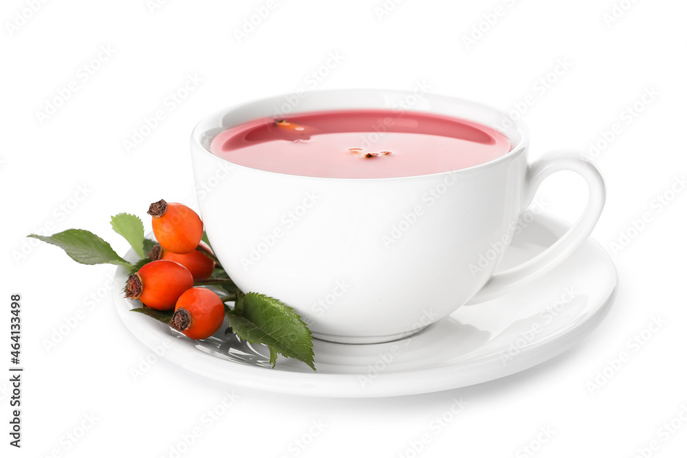 Cup of tasty rose hip tea and berries on white background