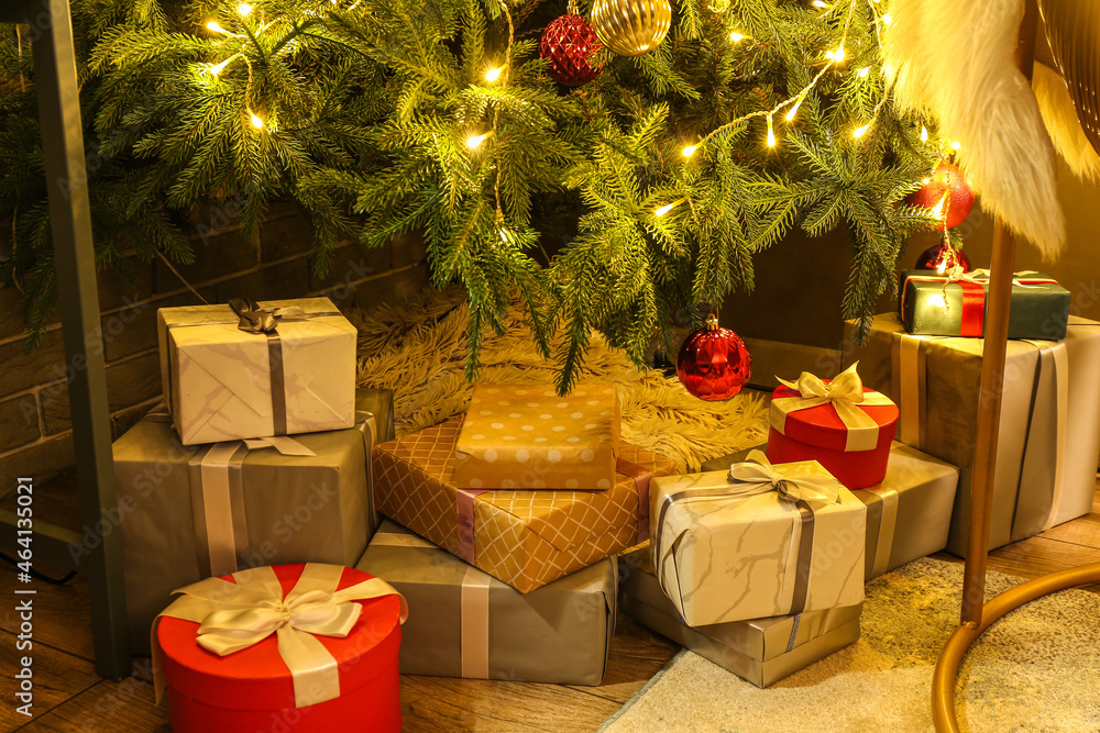 Many gifts under Christmas tree on floor