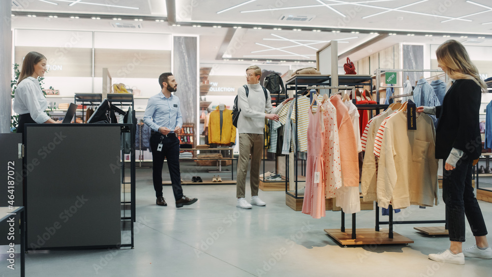 Customers Shopping in Modern Clothing Store, Retail Sales Associate Assists Clients. Diverse People 