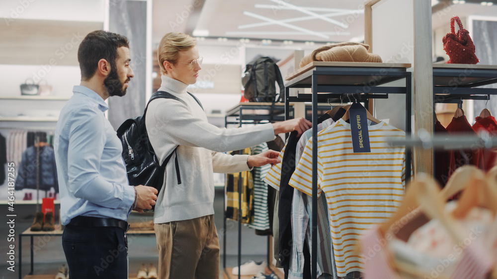 Handsome Male Customer Shopping in Clothing Store, Retail Sales Assitant Helps with Advice. Diverse 