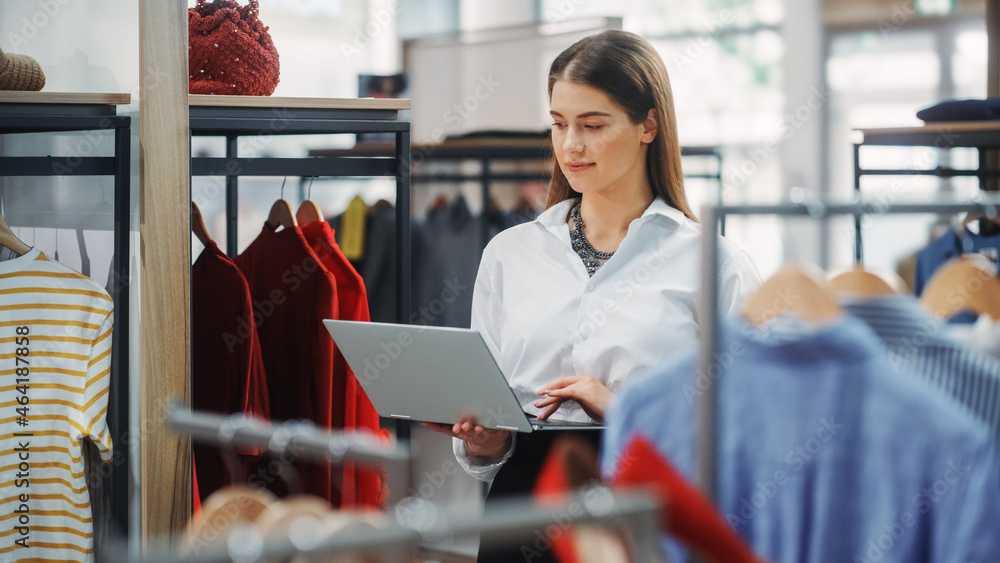 Clothing Store: Businesswoman and Visual Merchandising Specialist Uses Laptop To Create Stylish Coll