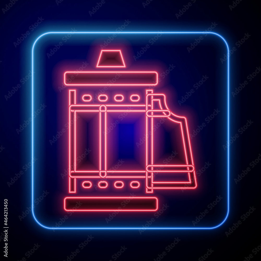 Glowing neon Camera vintage film roll cartridge icon isolated on black background. 35mm film caniste