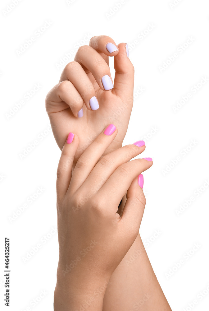 Female hands with different color nails on white background, closeup