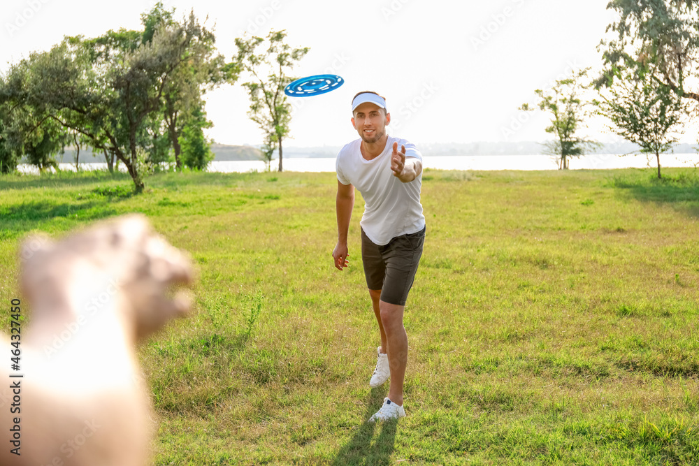 Young men playing frisbee in park