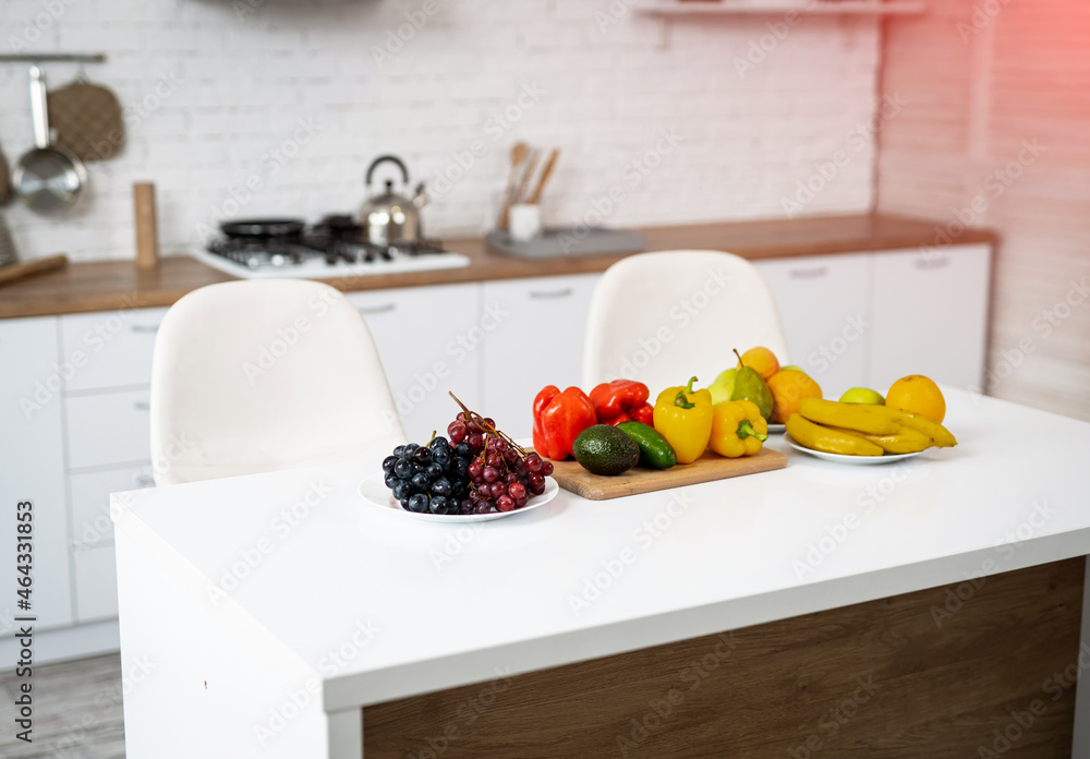 Healthy food, fruit, vegetable, berries , leaf vegetable on a table in a kitchen background. Organic