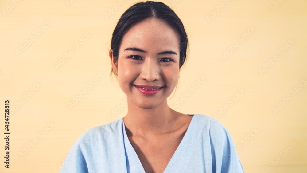 Portrait of young Asian woman merrily pose in studio on clear background .