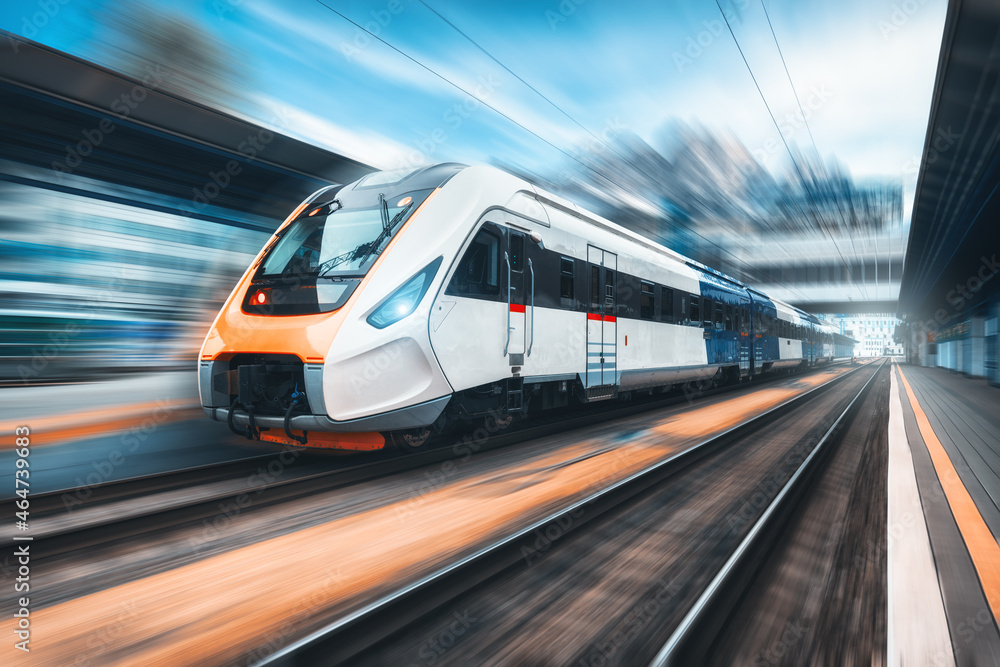 High speed train in motion on the railway station at sunset