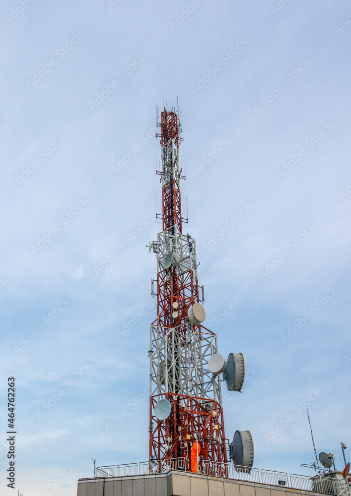 Large telecommunication tower against sky and clouds in background . Internet network connection con