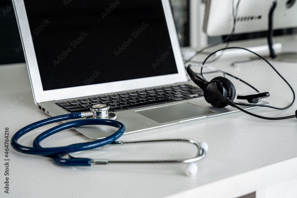 Headset and doctor equipment at clinic ready for actively support for patient by online video call .