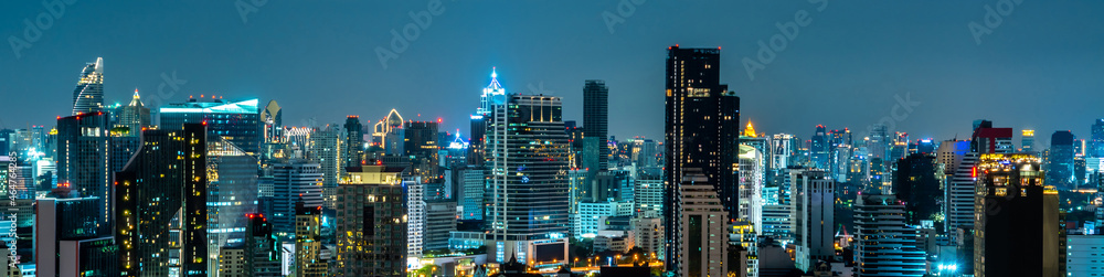 Night cityscape and high-rise buildings in metropolis city center . Downtown business district in pa