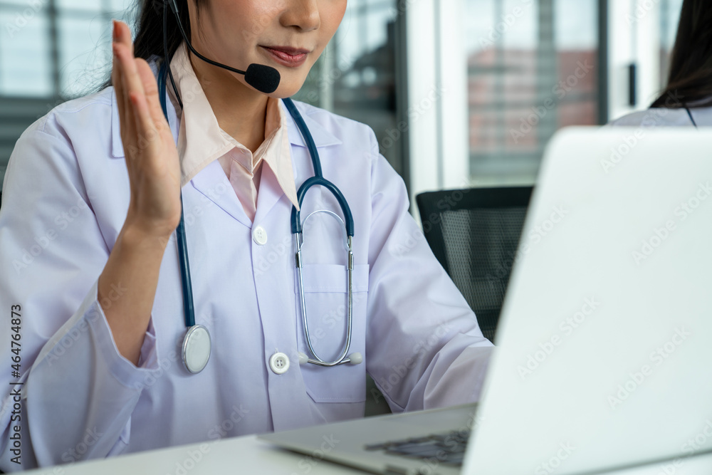 Doctor wearing headset talking actively on video call in hospital or clinic . Concept of telehealth 