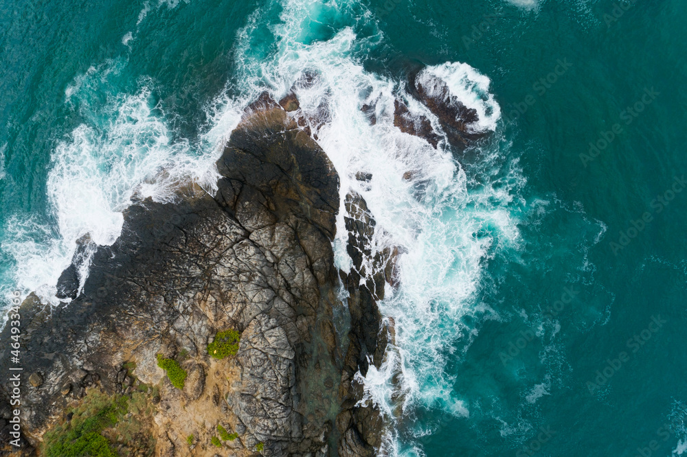 Aerial view of sea crashing waves White foaming waves on seashore rocks Top view fantastic Rocky coa