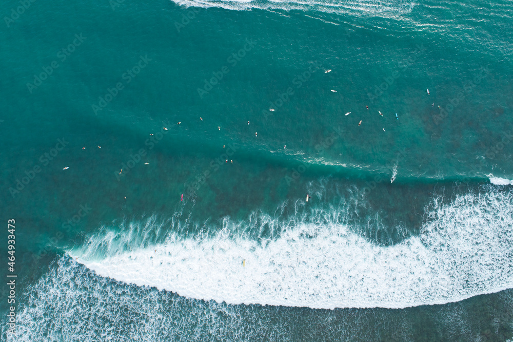 Amazing aerial view Top down of waves break on tropical sea Surfers with surfing boards Aerial drone