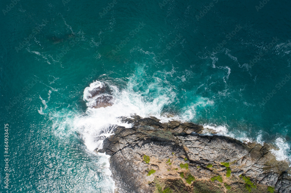 Aerial view of sea crashing waves White foaming waves on seashore rocks Top view Rocky coast