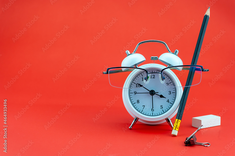 Concept Education or business Alarm clock and teacher glasses Business objects isolated on colorful 