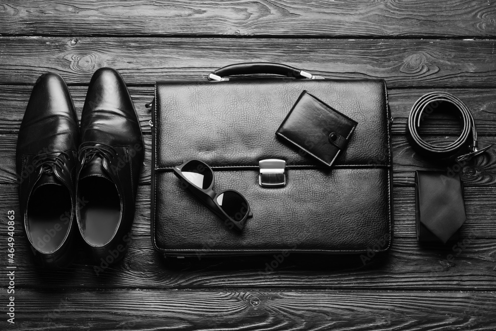 Set of stylish male accessories on dark wooden background