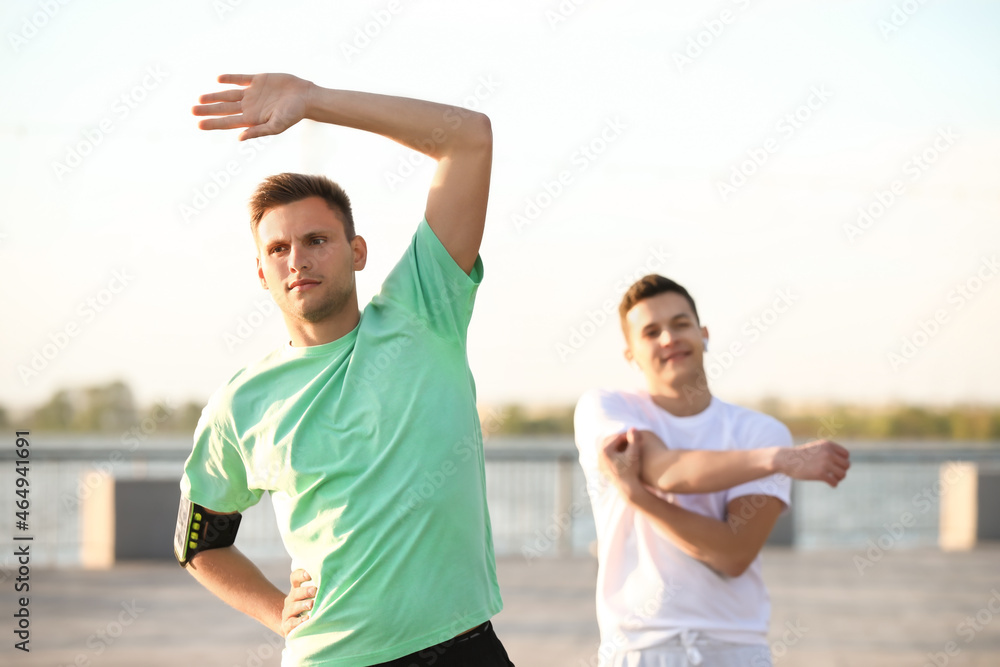 Sporty young man exercising outdoors