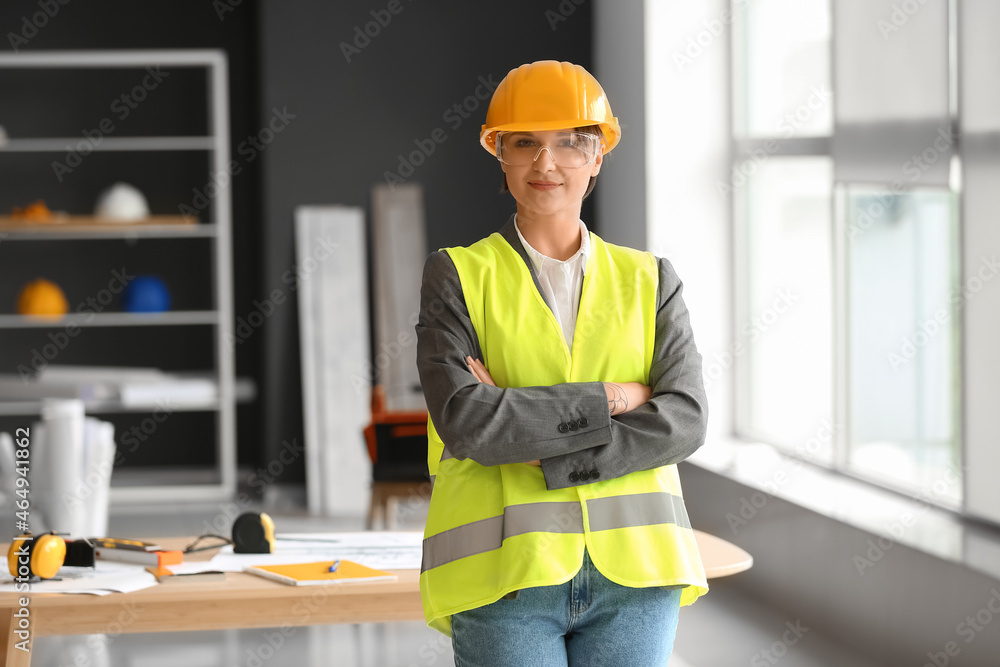 Female construction worker with hardhat in office