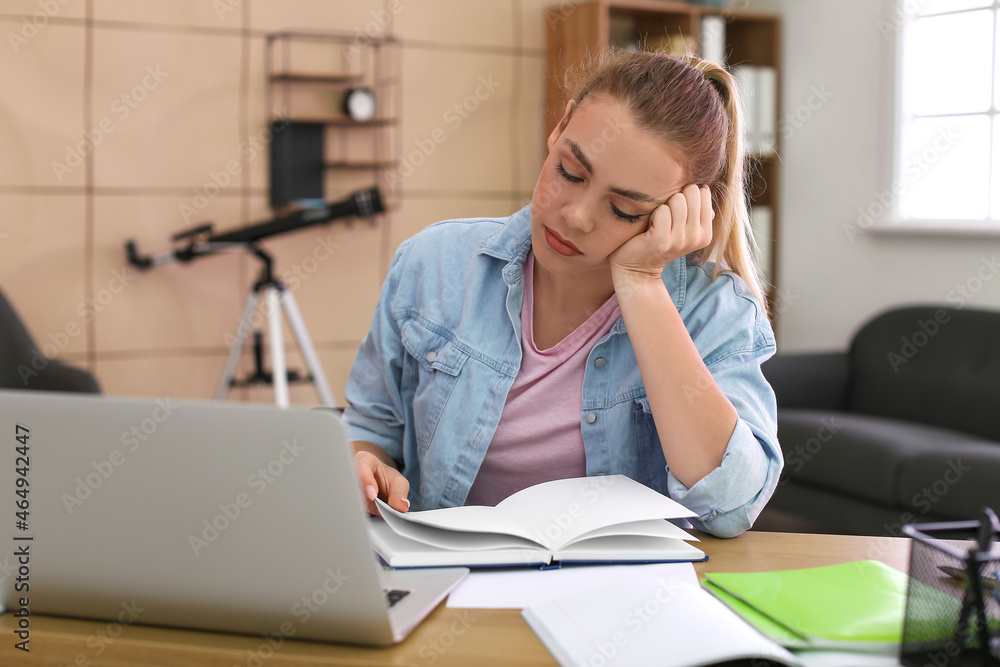 Female student preparing for exam at home