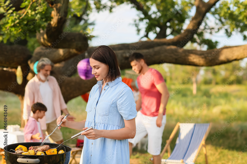 Happy family at barbecue party on summer day