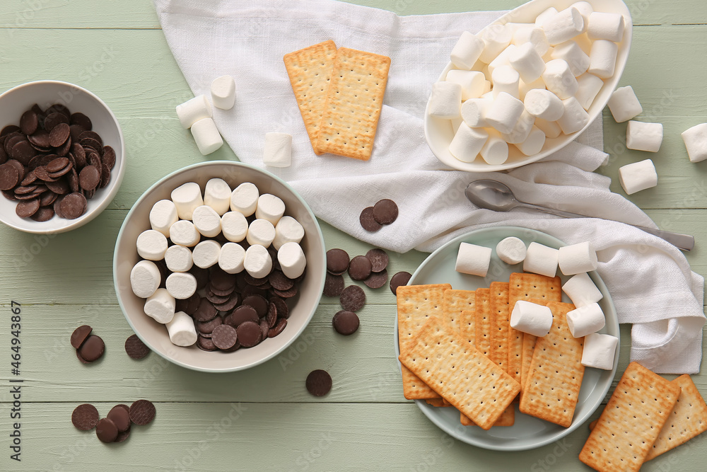 Ingredients for preparing Smores dip on color wooden background