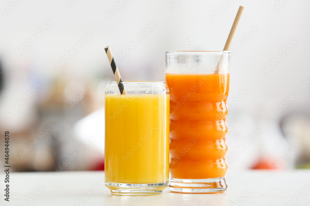 Glasses with healthy juice on table in room