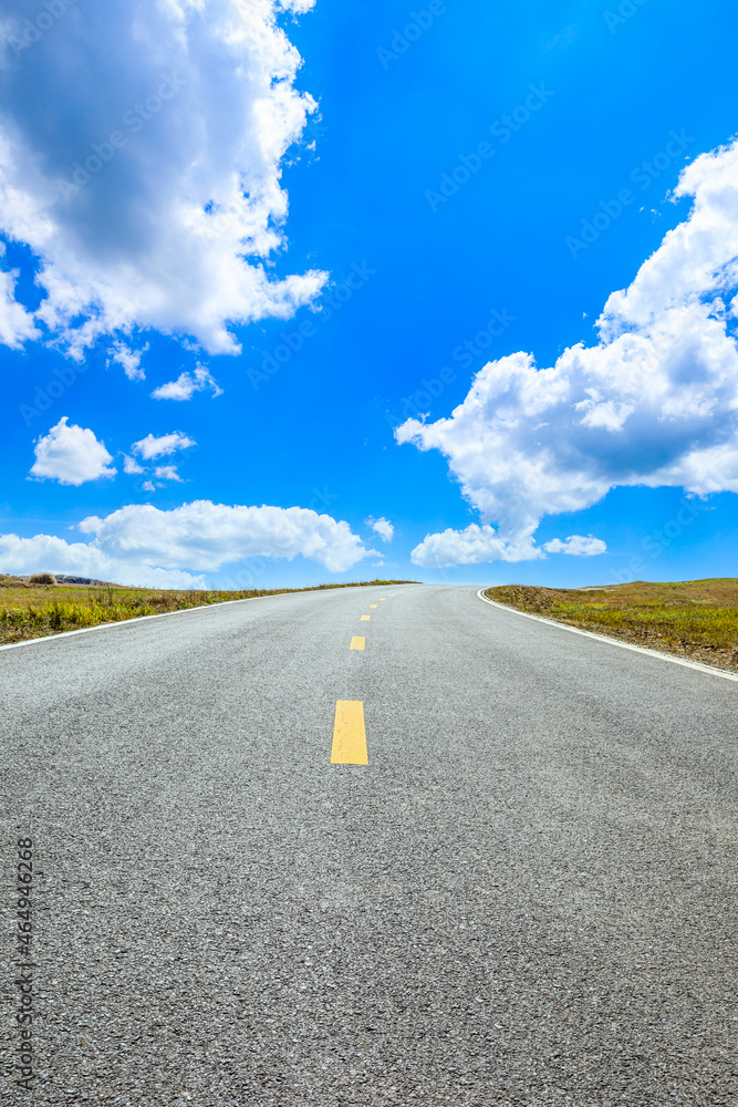 Empty asphalt road and mountain nature landscape under blue sky.