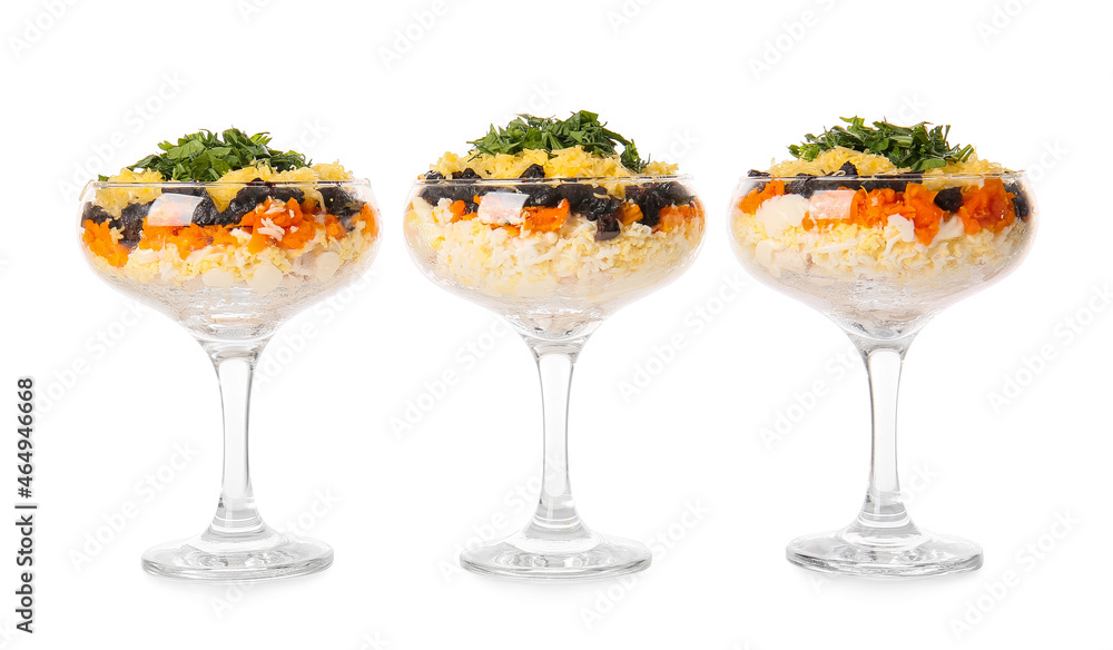 Delicious layered salad with prunes in glasses on white background