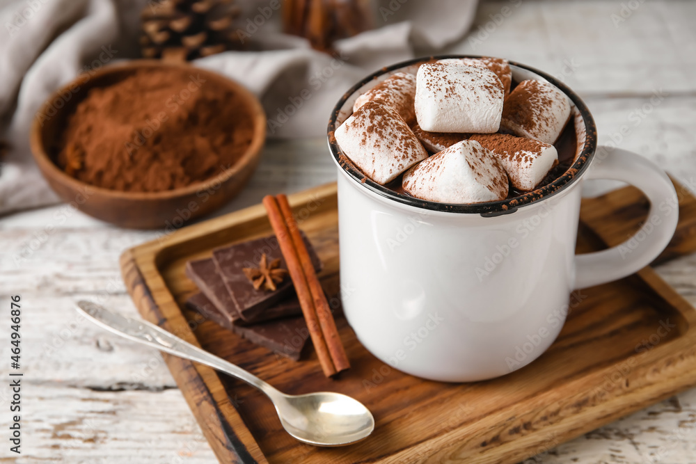 Mug of tasty hot chocolate on wooden background