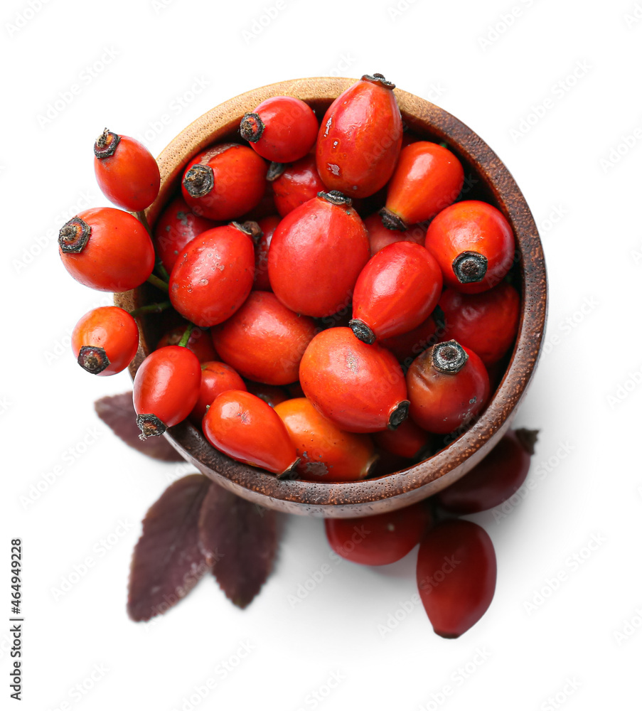 Bowl with fresh rose hip berries on white background