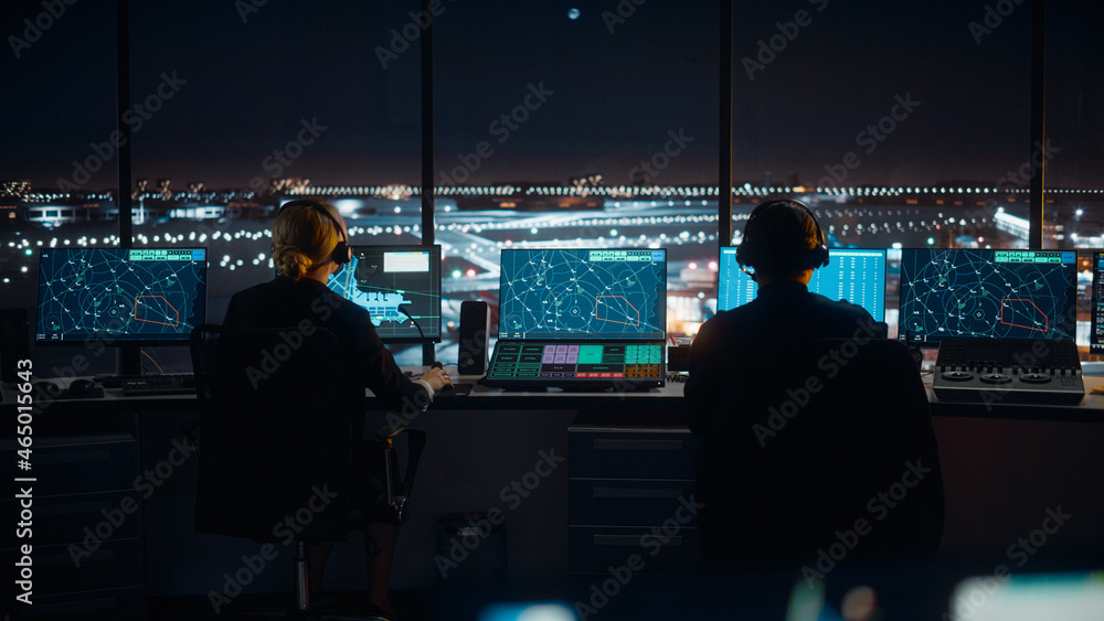 Diverse Air Traffic Control Team Working in a Modern Airport Tower at Night. Office Room is Full of 