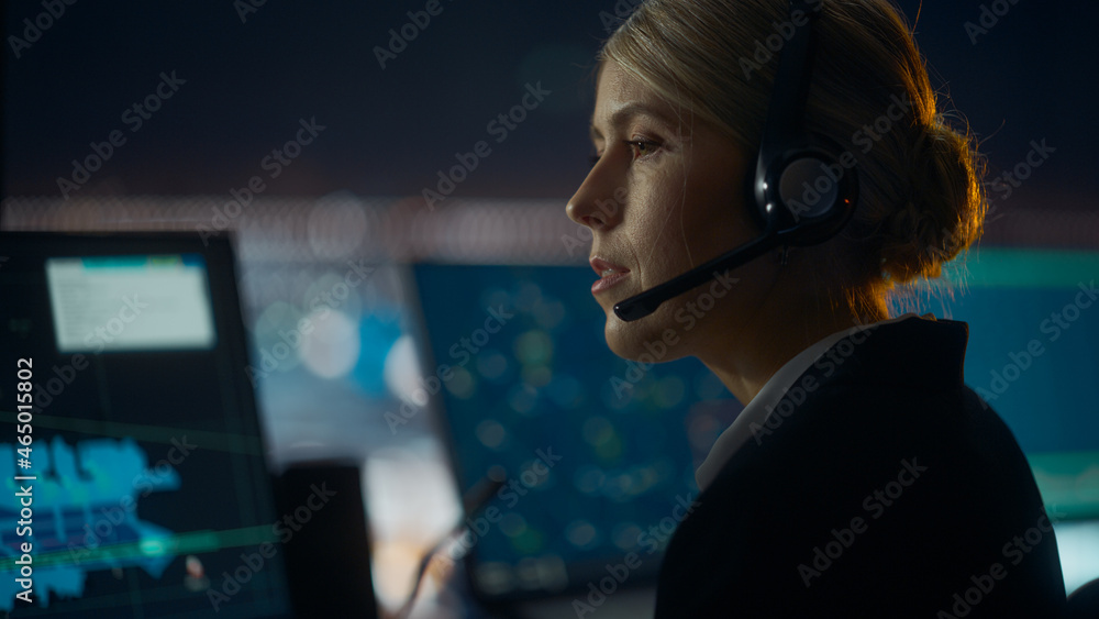 Close Up Female Portrait of Air Traffic Controller with Headset Talk on a Call in Airport Tower at N