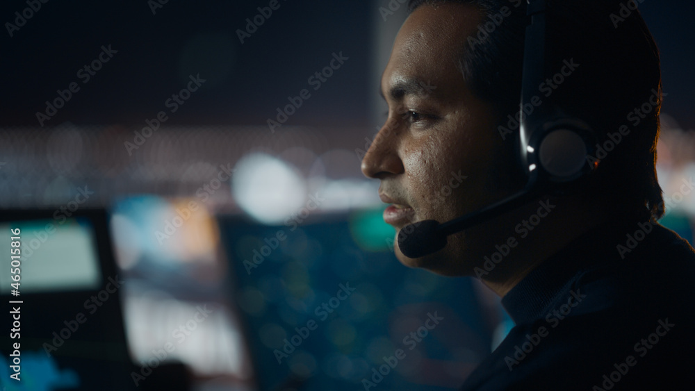 Close Up Portrait of Male Air Traffic Controller with Headset Talk on a Call in Airport Tower. Offic