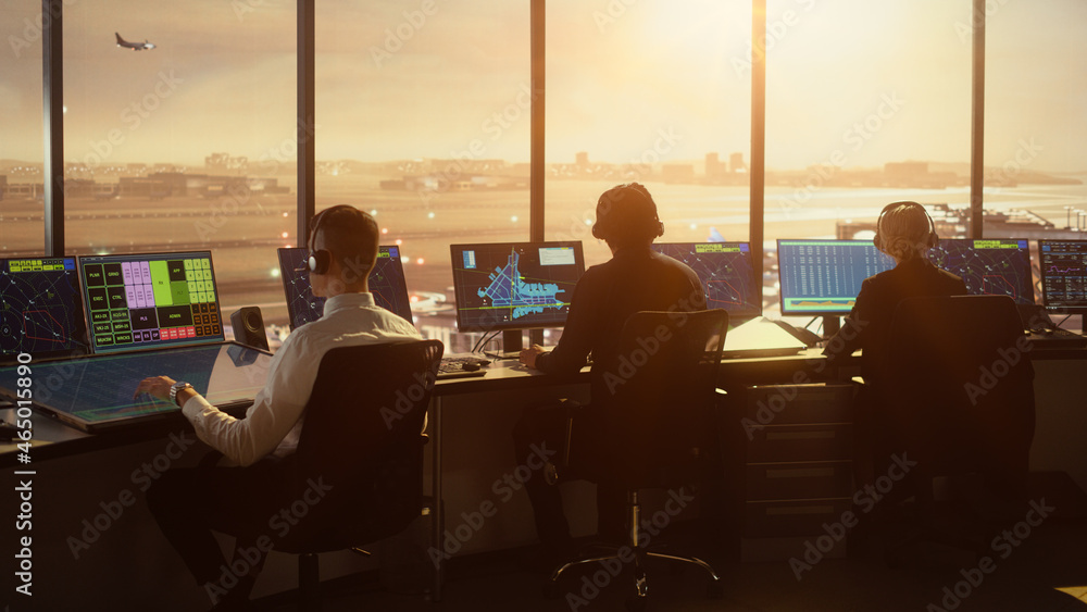 Diverse Air Traffic Control Team Working in a Modern Airport Tower at Sunset. Office Room is Full of