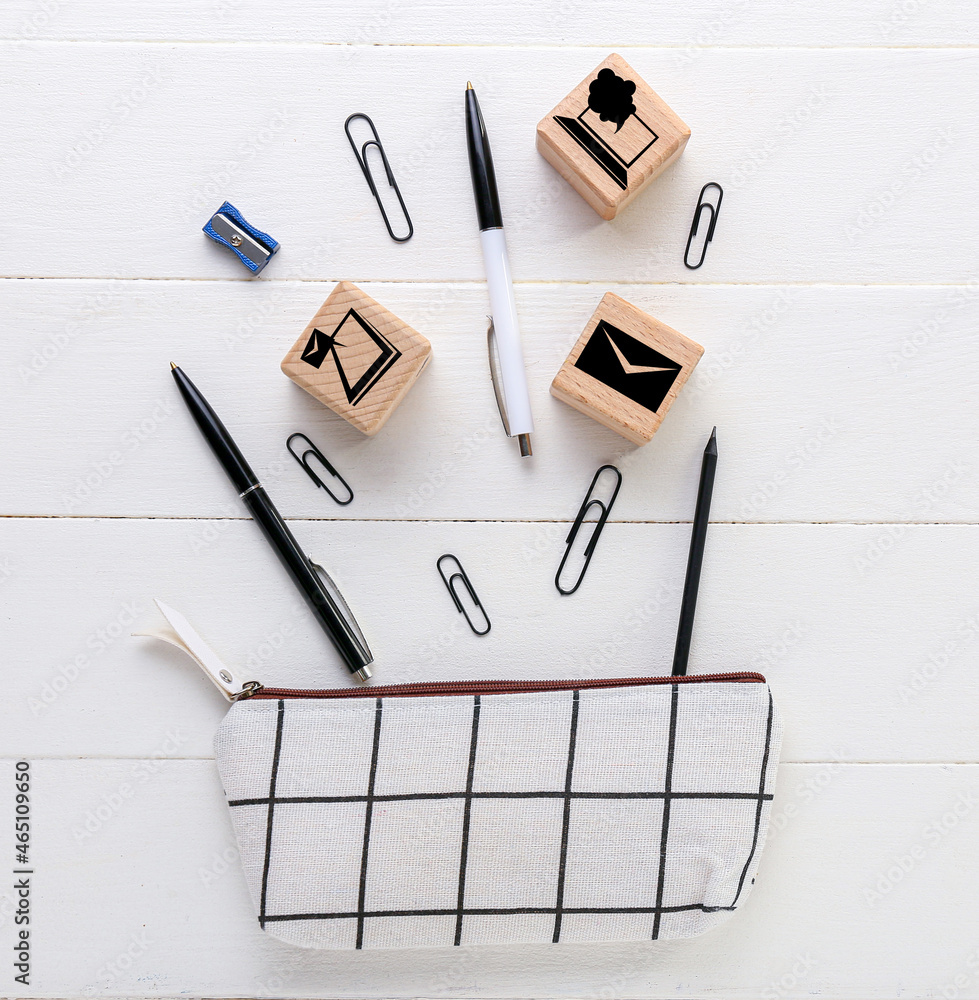 Cubes with stationery on white wooden background