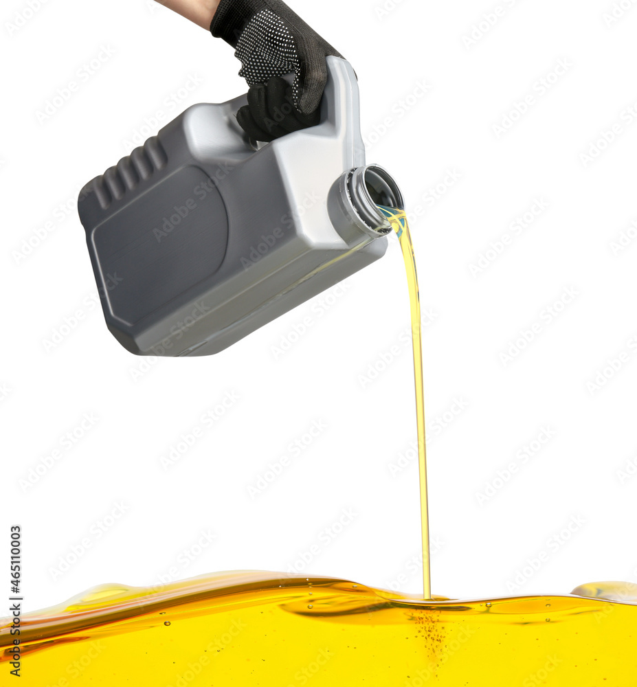 Pouring of car oil from canister against white background