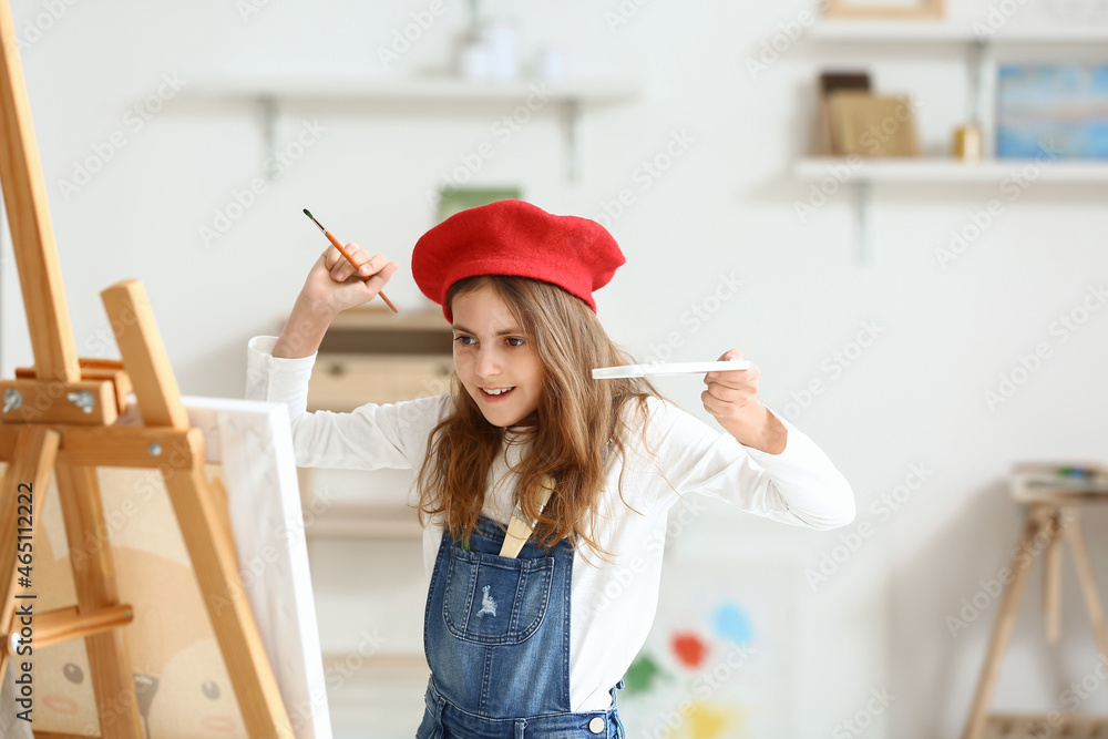 Cute little girl painting at home