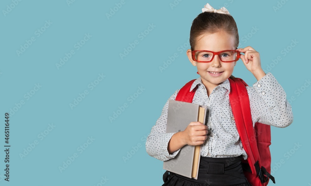 Smiling little kid with backpack hold books