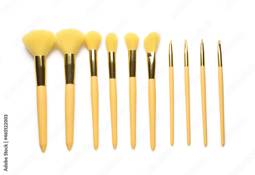 Different beautiful makeup brushes on white background