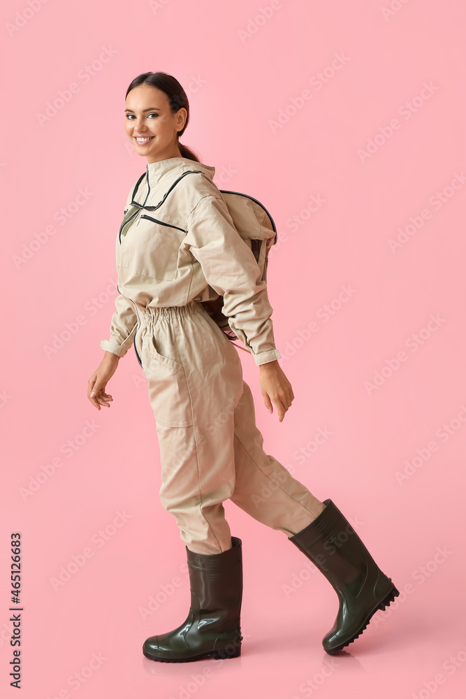 Female beekeeper on color background