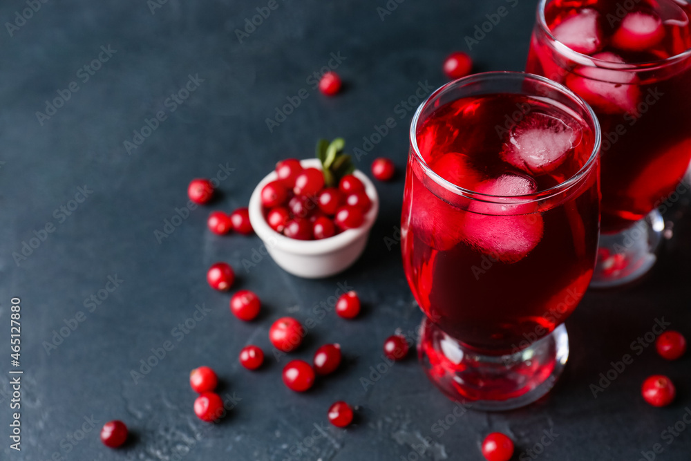 Glasses of cold lingonberry tea on dark background, closeup