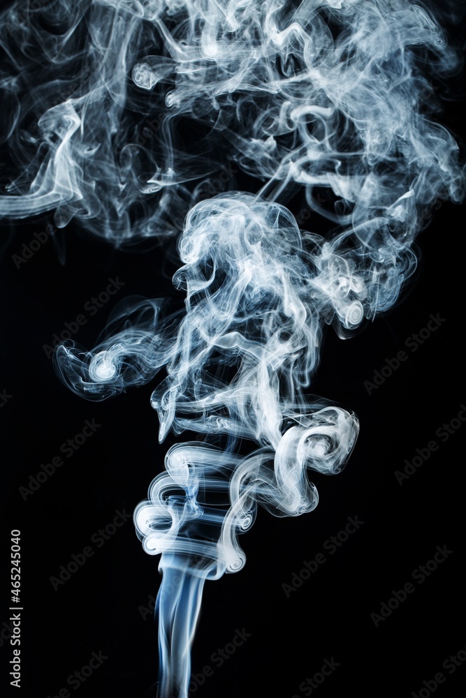 Abstract black smoke swirls over white background