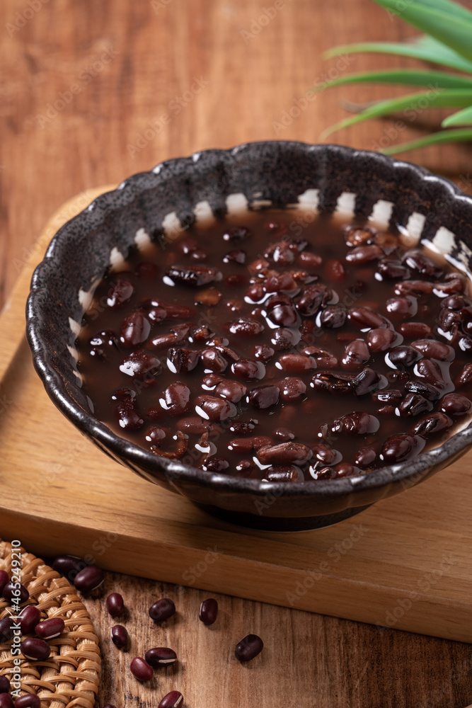 Adzuki red bean soup on wooden table background.