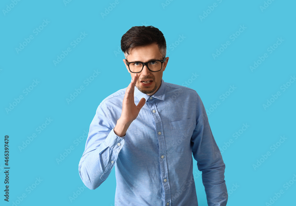 Gossiping man on color background